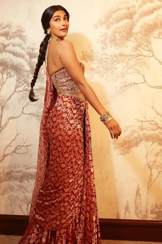 Actress Pooja Hegde posing elegantly in an embellished designer silk saree